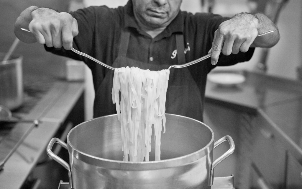 Piero's cook making pasta in kitchen
