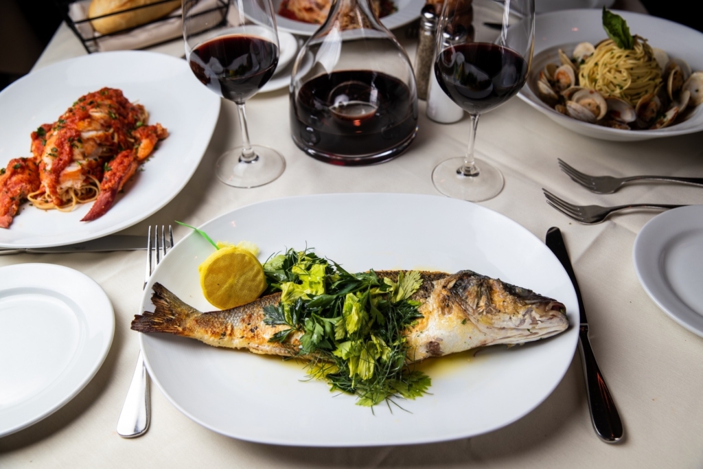 Branzoni Grilled Fish is a de-boned Italian sea bass specialty dish at Piero's. For a table like this, reservations can be booked online.